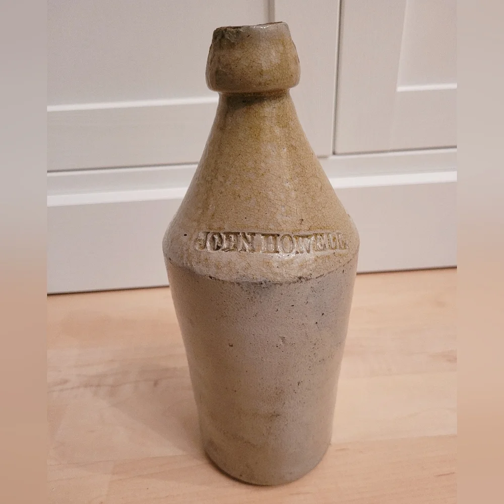 Antique John Howell cream beige pottery stoneware whiskey jug